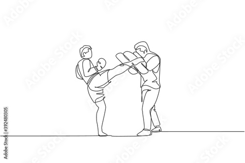 Single continuous line drawing of young sportive man kickboxer exercise with personal trainer and punch bag in sport hall. Fight kickboxing sport concept. One line draw design vector illustration
