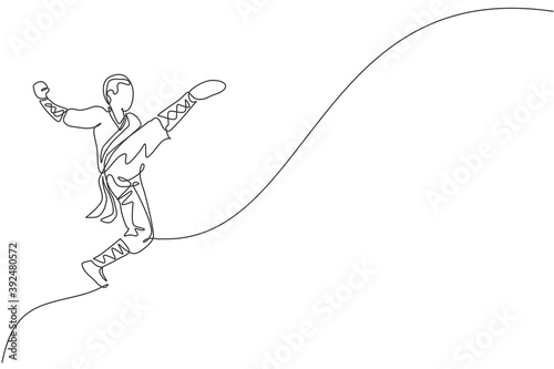 Fotografia Single continuous line drawing young muscular shaolin monk man train jumping kick at shaolin temple