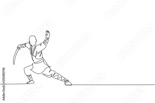 Obraz na plátně One single line drawing of young energetic shaolin monk man exercise kung fu fighting with sword at temple vector illustration