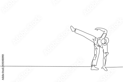 One continuous line drawing capoeira young sporty Brazilian fighter man training capoeira on beach. Healthy traditional fighting sport concept. Dynamic single line draw design vector illustration