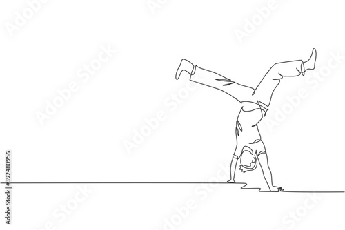 Single continuous line drawing of young sportive man practice Brazilian capoeira move dance at outdoor street. Culture martial art and sport concept. Trendy one line draw design vector illustration