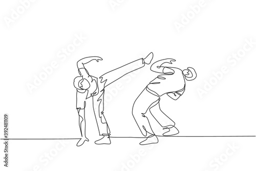 Single continuous line drawing of two young sportive men practice Brazilian capoeira move dance at outdoor street. Culture martial art sport concept. Trendy one line draw design vector illustration