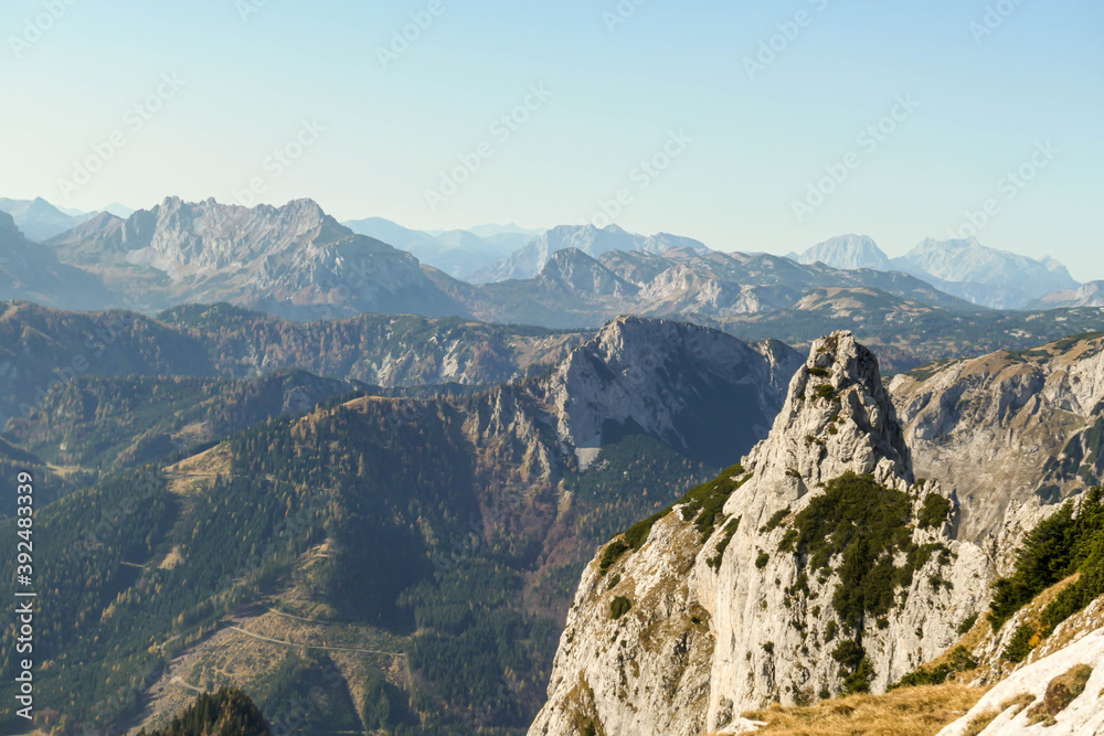 Panoramic view on mountains in Hochschwab region, Austrian Alps. The flora overgrowing slopes is golden. Autumn vibes in the mountains. Remote place, with no people. Freedom and wilderness