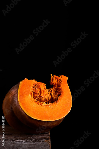 Pumpkin slice over black background with copy space.Close up