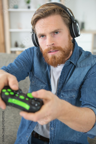 man playing video game with headphones