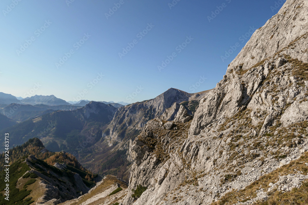 Panoramic view on mountains in Hochschwab region, Austrian Alps. The flora overgrowing slopes is golden. Autumn vibes in the mountains. Remote place, with no people. Freedom and wilderness