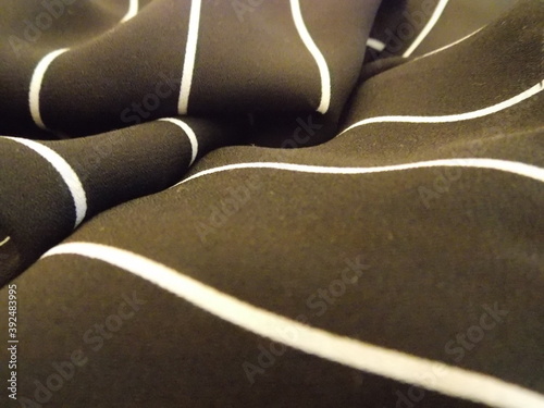 Dark textile with thin white stripes 