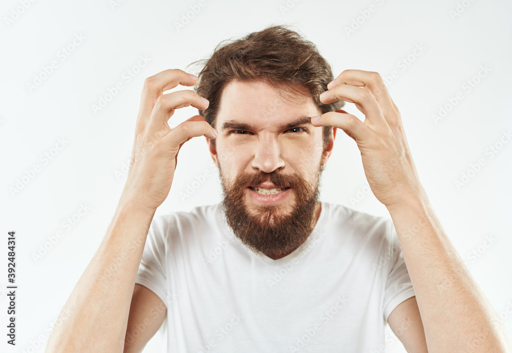 Energetic man in white t-shirt bushy beard gestures with hands cropped view Energetic man in white t-shirt bushy beard gestures with hands cropped view