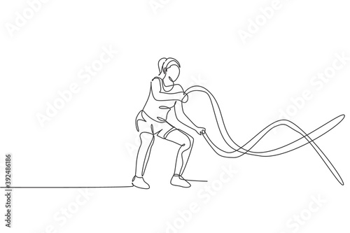 Fototapeta Naklejka Na Ścianę i Meble -  One single line drawing of young energetic woman exercise with battle rope in gym fitness center vector illustration graphic. Healthy lifestyle sport concept. Modern continuous line draw design