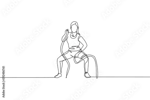 Single continuous line drawing of young sportive woman training with battle rope in sport gymnasium club center, front view. Fitness stretching concept. Trendy one line draw design vector illustration