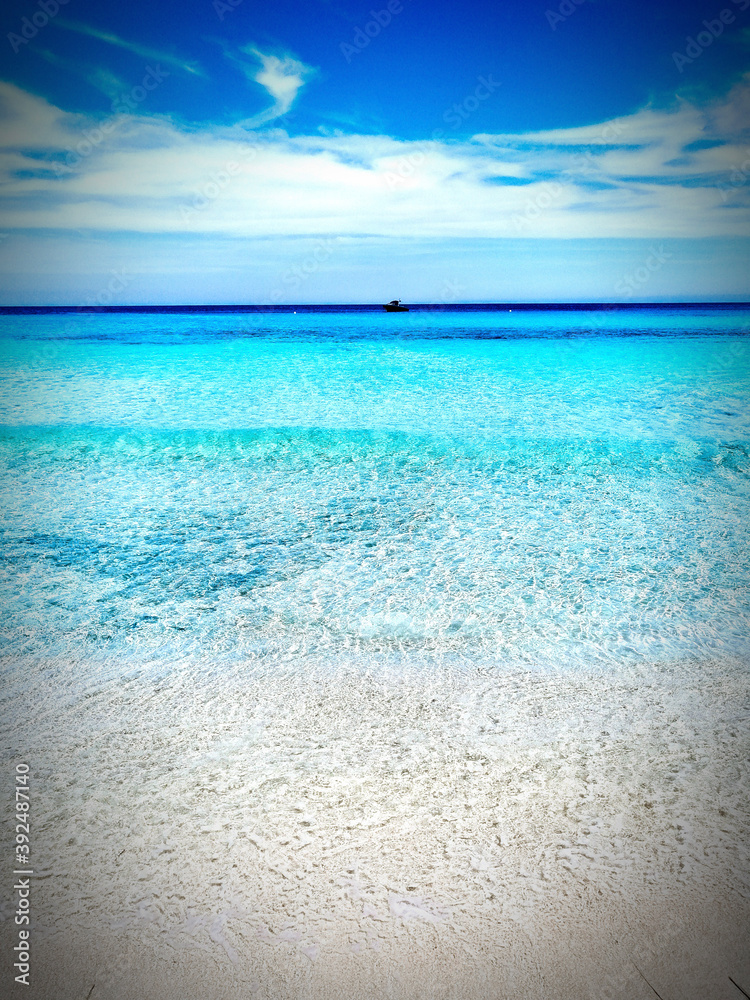 Fototapeta premium Crystal clear blue sea in the background clouds.