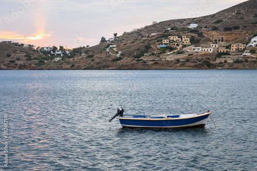 A boat moored in the bay during evening on Ios Island. Cyclades, Greece © vivoo