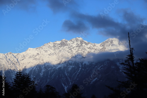 A early winter blue morning at a snowy mountain and a hut in Katao, Sikkim India 