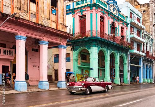 convertible classic car in front of colorful houses in havana cuba © Michael Barkmann