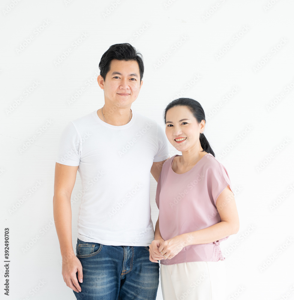 Isolated on white background.Studio portrait of young asian couple dress in casual looking at camera smiling, waist up. Isolated on white background.Studio portrait of young asian couple dress in casual looking at camera smiling, waist up.