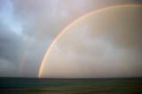 bright beautiful colorful double rainbow over the sea