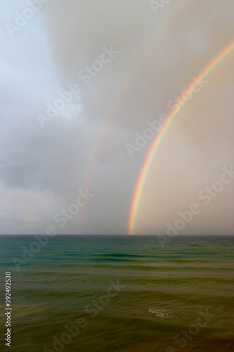 bright beautiful colorful double rainbow over the sea