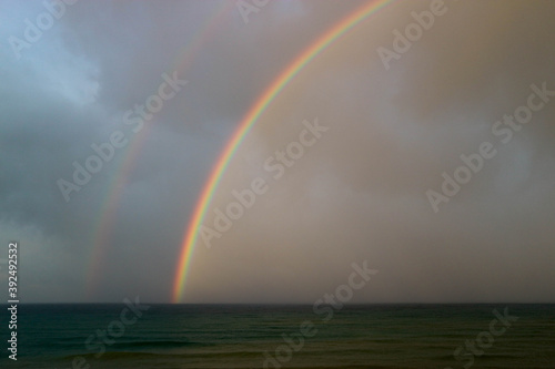 bright beautiful colorful double rainbow over the sea