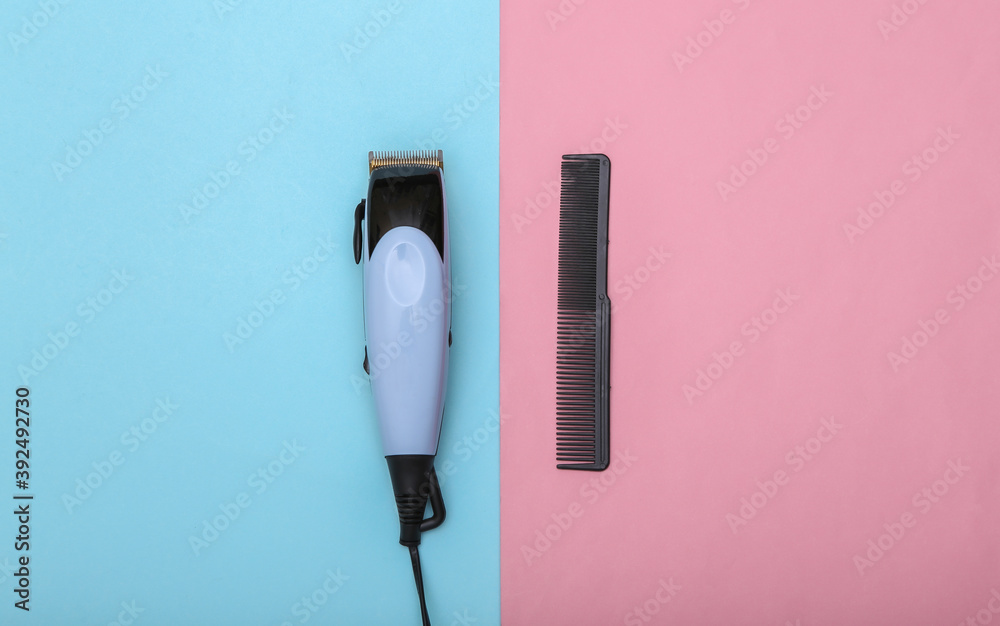 Hair clipper and comb on pink blue background. Barber tool. Top view Hair clipper and comb on pink blue background. Barber tool. Top view