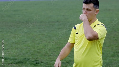 Referee goes watching VAR or violation of the rules and shows a penalty, yellow or red card . Concept of sport, rules violation, offside
