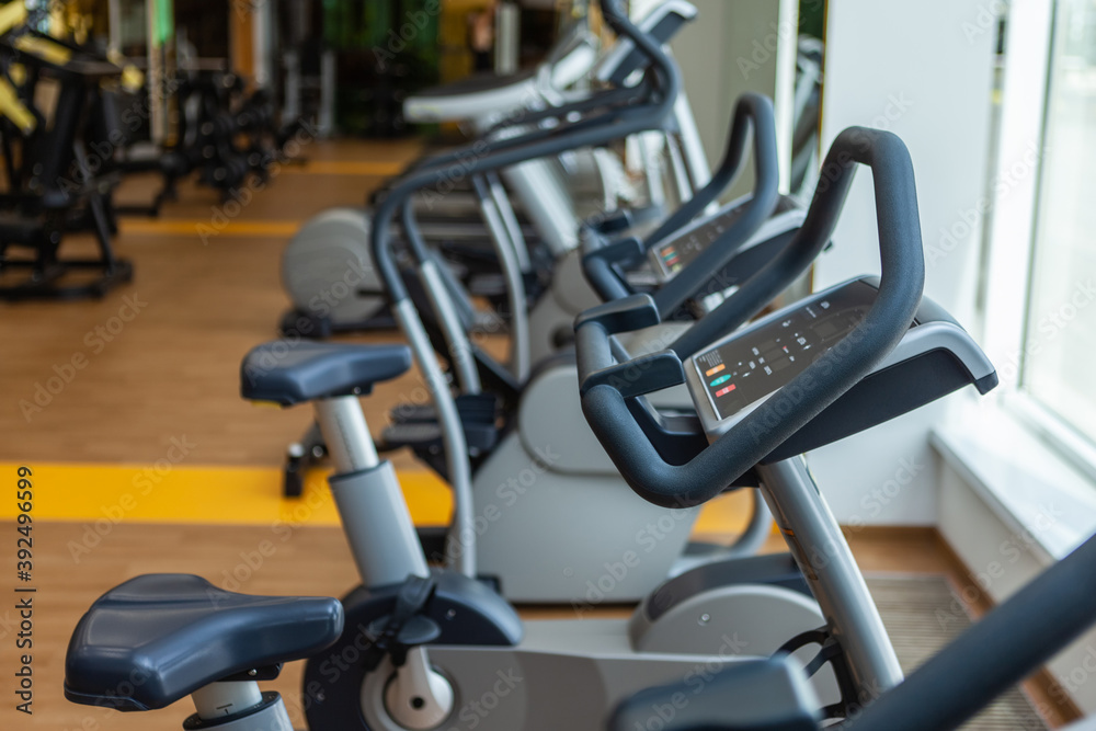 Close up of fitness bicycles in modern gym interior