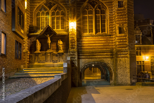 Evening cityscape - view of The Vleeshuis (Butchers Hall, or literally Meat House) and sculptural group referring to the theme of Calvary (Christ, Mary, John), in Antwerp, Belgium