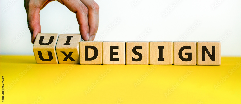 UX design or UI design. Hand turns cubes and changes the words 'UX ...