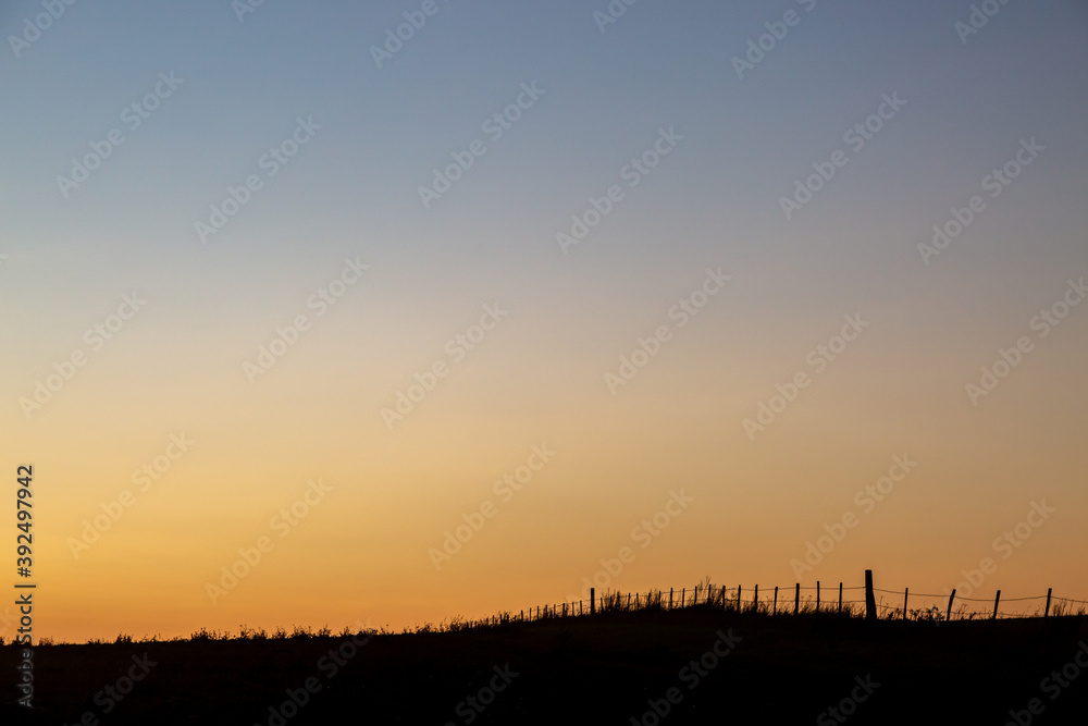 Silhouetted Farmland at Sunset