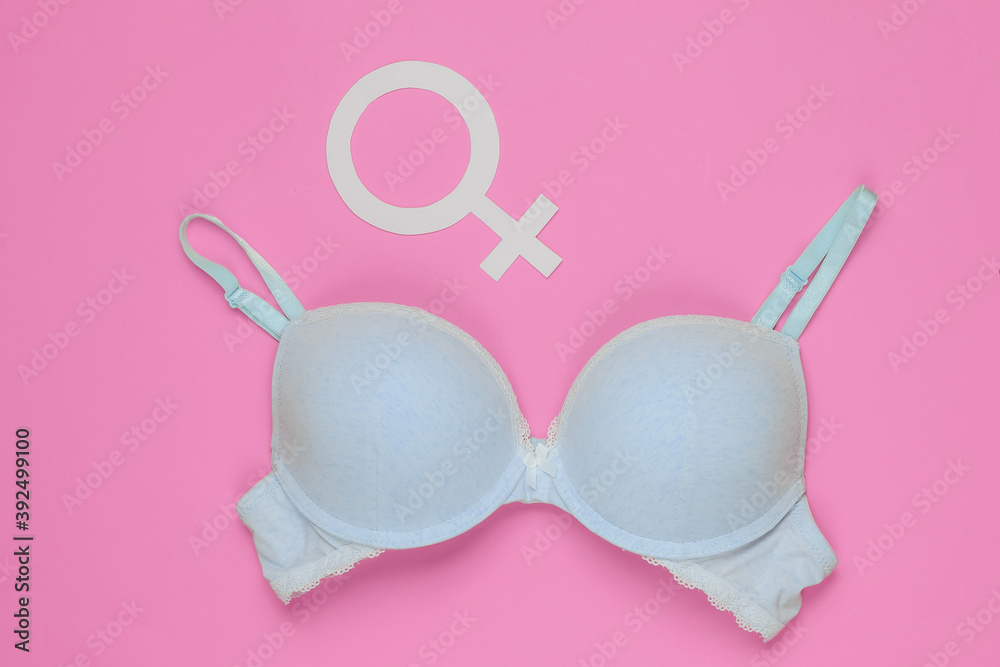 Underwear bra and gender Femen symbol on pink background. The concept of feminism. Underwear bra and gender Femen symbol on pink background. The concept of feminism.