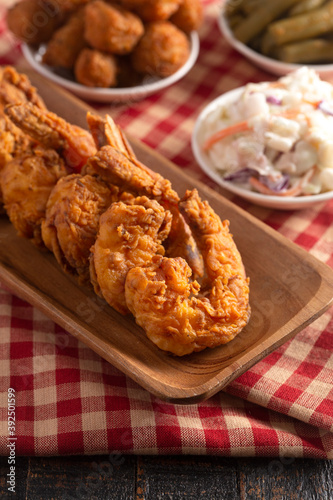 Breaded and Fried Jumbo Shrimp with Tails on a Wooden Table