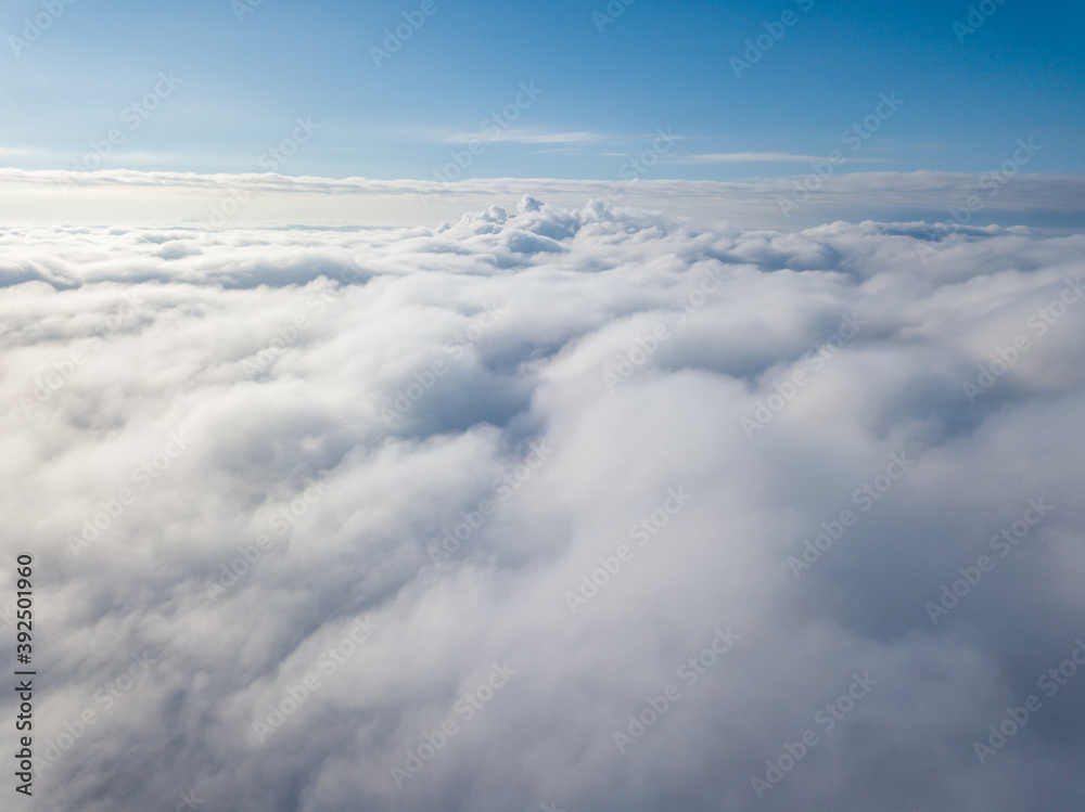 Aerial view. Flying over white clouds during the day in sunny weather. Aerial view. Flying over white clouds during the day in sunny weather.
