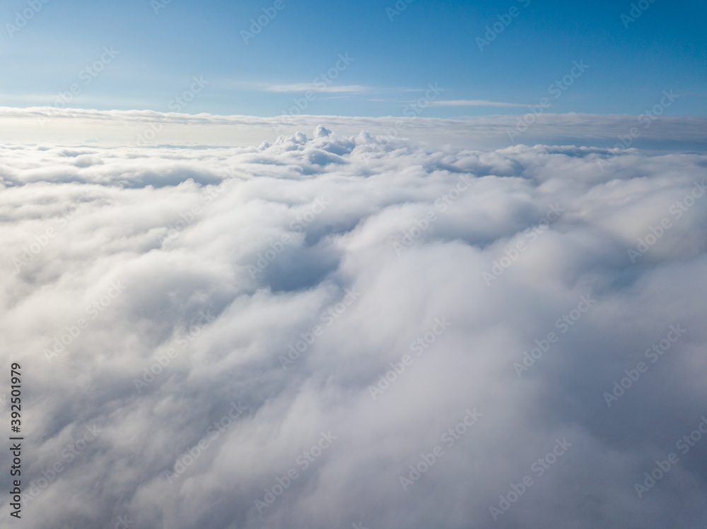 Aerial view. Flying over white clouds during the day in sunny weather. Aerial view. Flying over white clouds during the day in sunny weather.