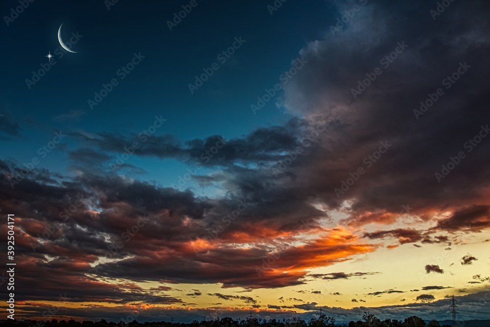 Ramadan background with a crescent and sunset sky . beautiful dawn in the morning