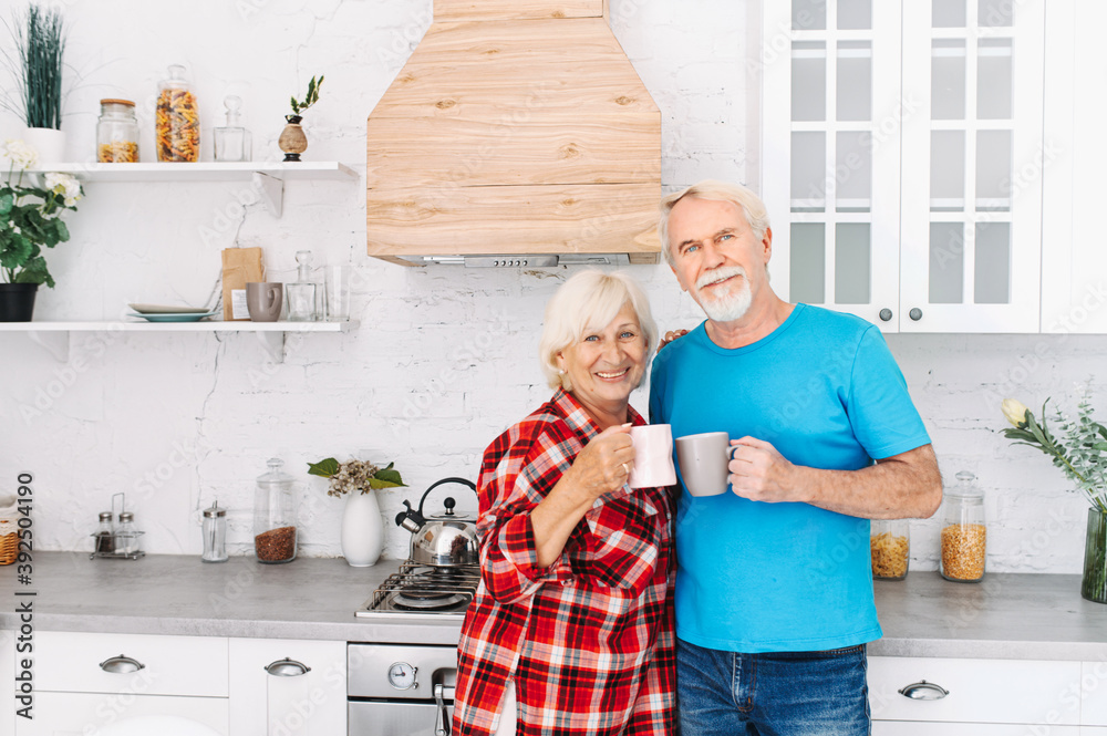 Senior couple drinks tea in the kitchen Senior couple drinks tea in the kitchen