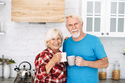 Senior couple drinks tea in the kitchen