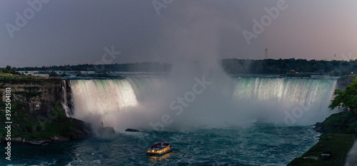 Close up view of Niagara falls in night with tourist bout at the bottom of falls  shooted from Canadien side