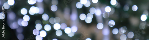 Christmas decorations - multicolored garlands. Selective soft focus. Snowflake from New Year's lanterns. Banner.