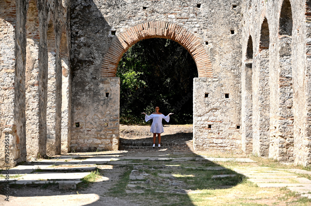 Young girl exploring an ruins of ancient city of Butrint.
