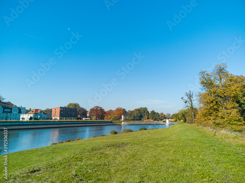 Colorful city fall landscape with buildings and river photo