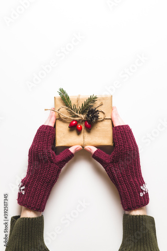 Christmas composition. Female hands keeping christmas gifts isolated on white. Flat lay, top view, copy space.