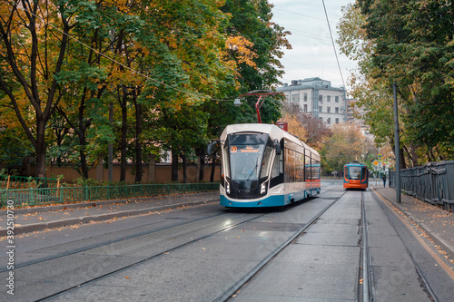 Photography Two modern trams driving along Dostoevsky Lane in different directions