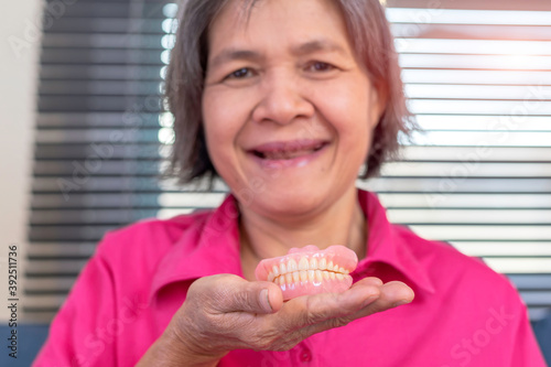Elderly Asian ying rejoices with dentures