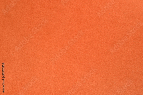 On an orange fabric background  a frame made of live fluffy pine branches.
