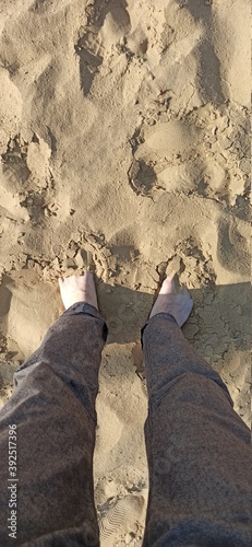 Feet in the sand. Sunny day at the beach. Sand, desert, beach.