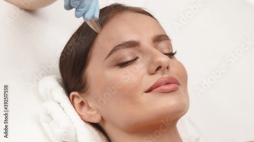 pretty woman face and erbium laser working on it