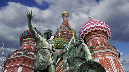 Minin and Pojarsky monument (was erected in 1818) near the Saint Basil cathedral (Temple of Basil the Blessed) against the moving clouds, Red Square in Moscow, Russia photo