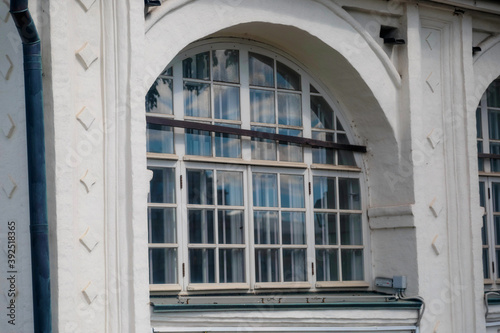 Part of the facade of a building and a large window of a Christian cathedral