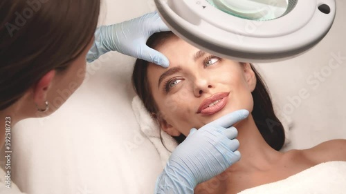 lovely female on face check at beauty clinic