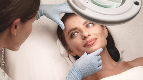 pretty woman with perfect skin checking in cosmetology doctor