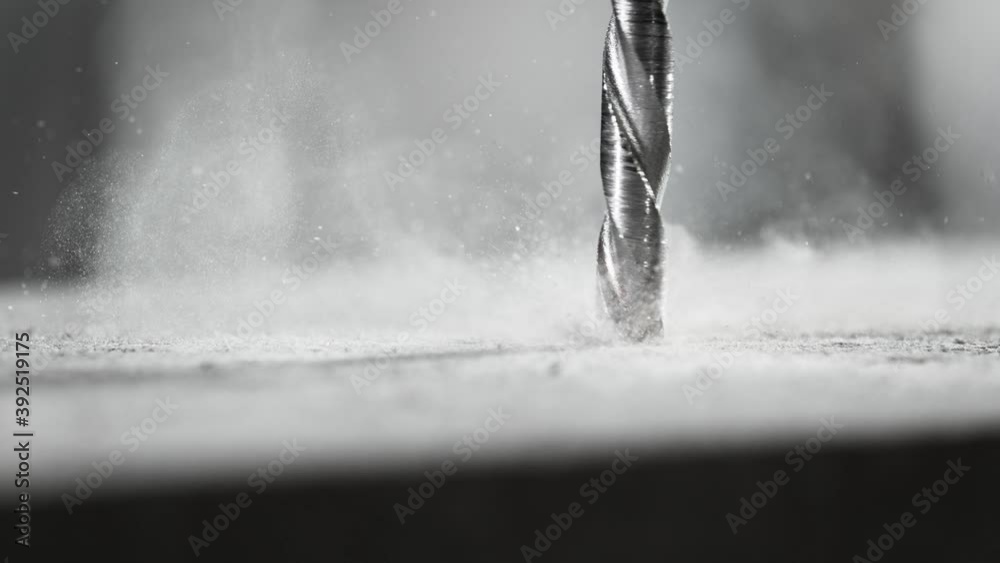 Super slow motion of detail of a drill bit drilling into concrete. Filmed on very high speed cinema camera, 1000 fps.
